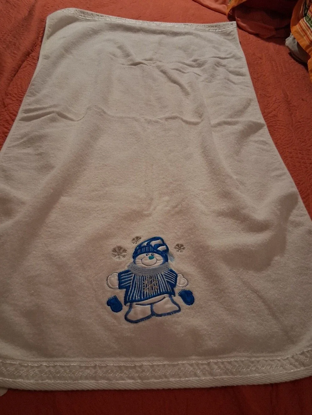 White Bath Towel With A Snowman Design On It